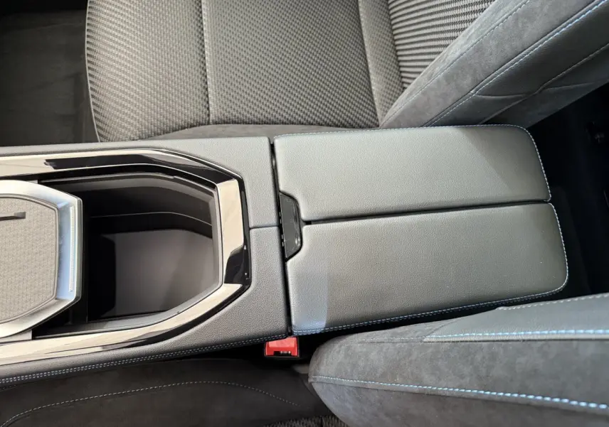 Vue rapprochée de la console centrale cuir noir avec surpiqûres bleues et accoudoir du Renault Espace gris foncé esprit Alpine 2025.