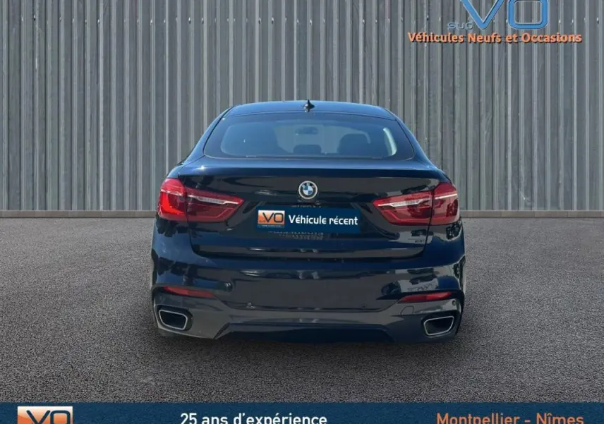 Vue arrière d'un BMW X6 noir F16 xDrive40d 2017 avec double sortie d'échappement et feux LED distinctifs.