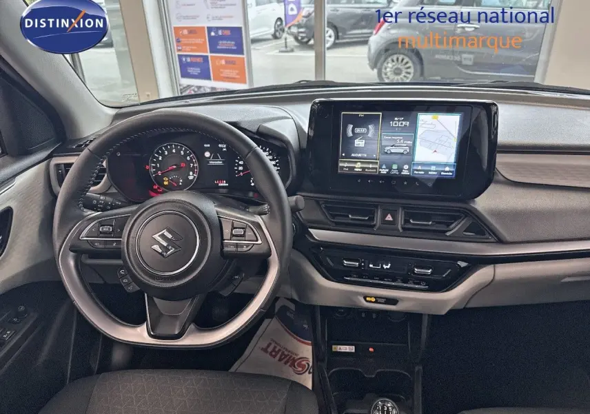 Vue intérieure du poste de conduite de la Suzuki Swift 1.2 Pack Hybrid 2024, avec volant multifonction et écran tactile central.