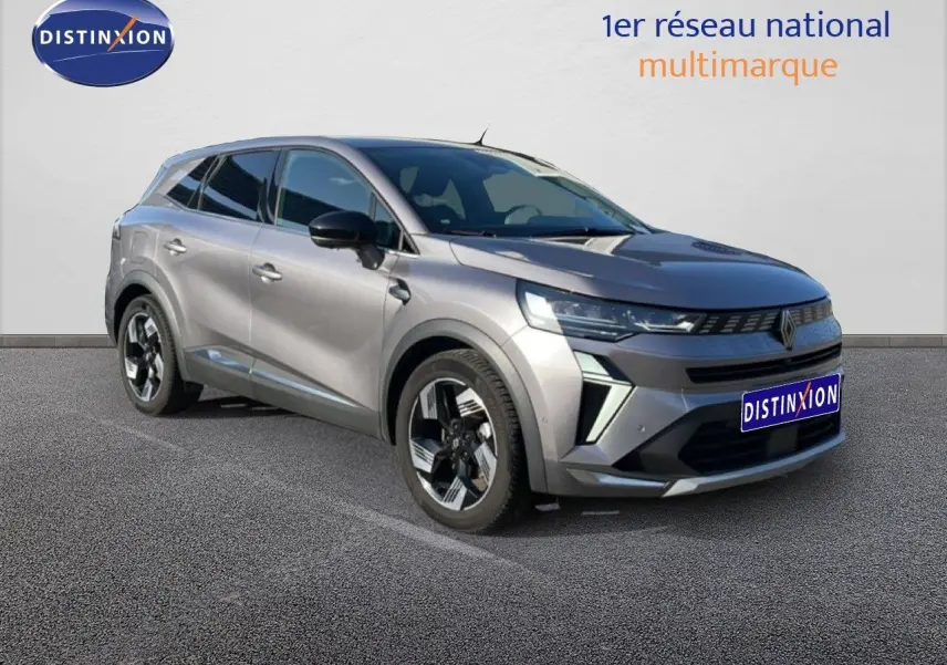 Renault Symbioz gris cassiopée métal en 3/4 avant droit, SUV hybride avec jantes noires et détails modernes.