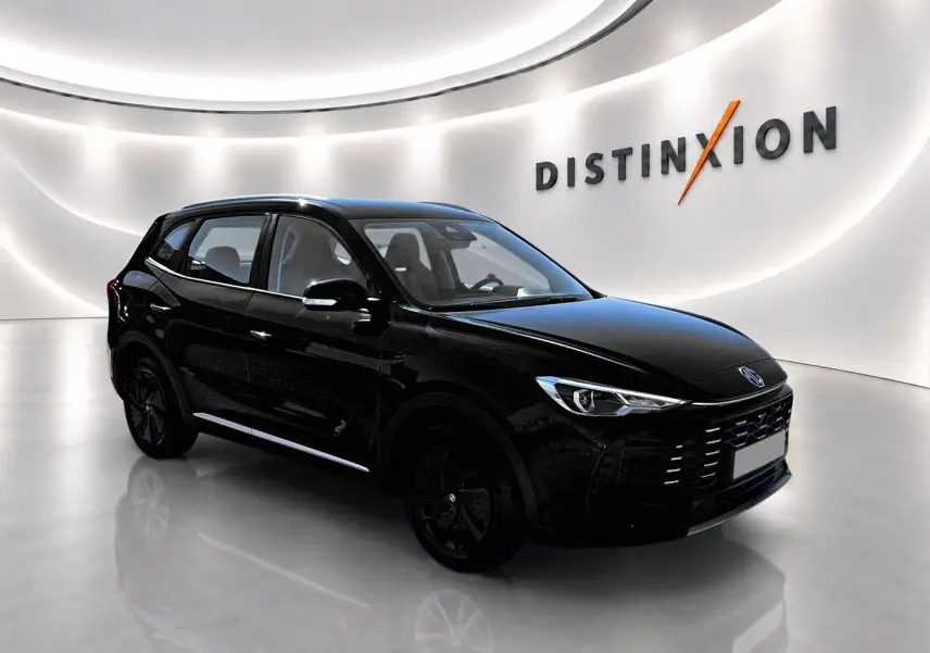 MG Motor ZS 1.5 hybrid noir en 3/4 avant droit, avec calandre marquée et jantes noires dans un showroom lumineux.