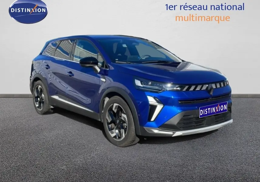 Renault Symbioz 2025 bleu Iron Metal en 3/4 avant droit, SUV hybride avec détails noirs et jantes bicolores.