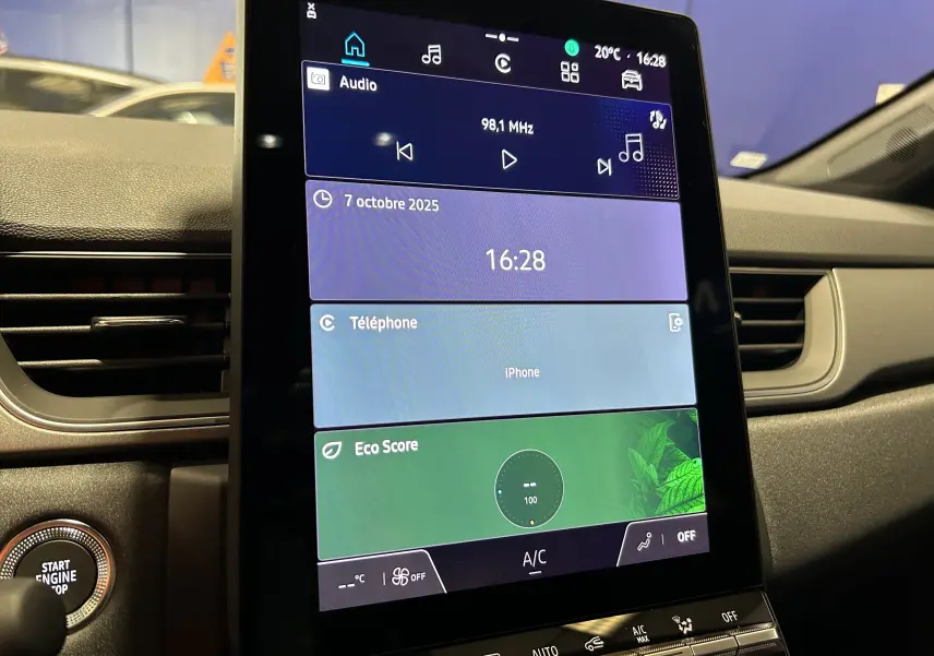 Écran tactile central allumé du tableau de bord d'une Renault Captur II Ph.2 TECHNO noir étoilé, avec commandes climatisation visibles.