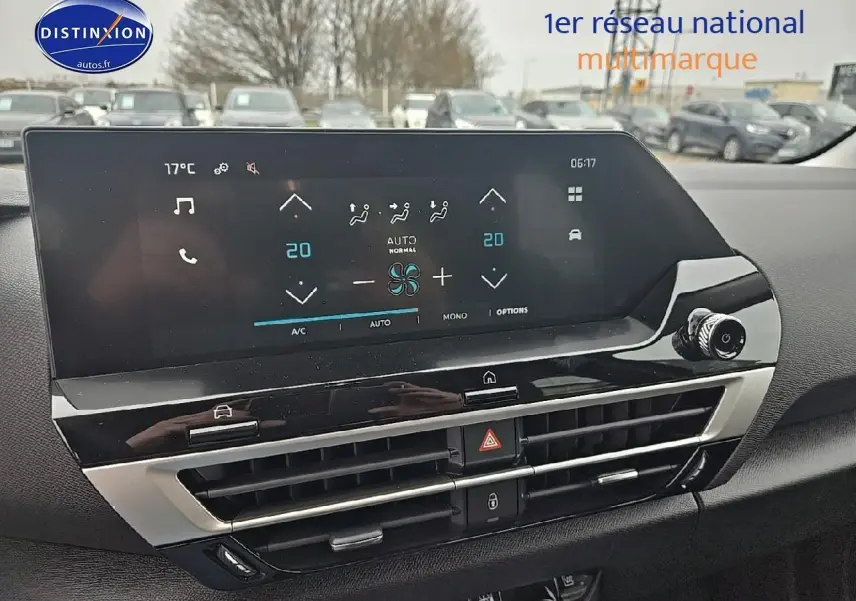 Vue rapprochée de l’écran tactile 10 pouces et commandes de climatisation du tableau de bord d’une Citroën C4 noire.