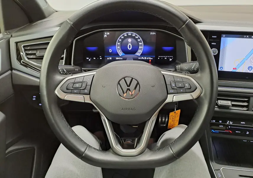 Vue intérieure centrée sur le volant cuir noir avec logo VW et tableau de bord numérique de la Volkswagen Polo 2025.