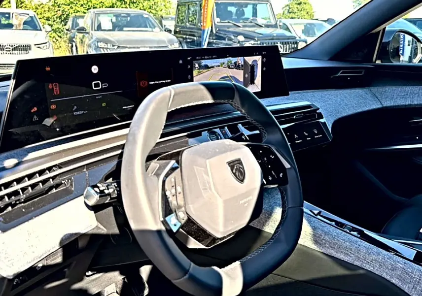 Vue intérieure côté conducteur du Peugeot 3008 1.2 hybrid 145 allure e-dcs6 avec volant cuir et écran tactile large.