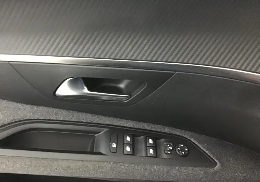 Poignée de porte intérieure côté gauche avec commandes des vitres et rétroviseurs du Peugeot 5008 noir 2019.
