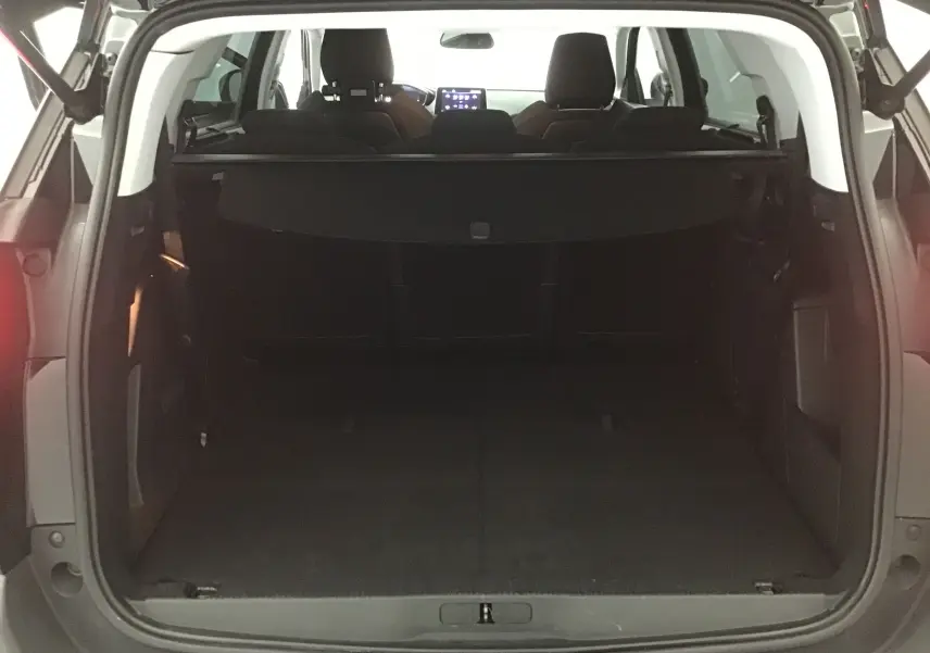Coffre ouvert du Peugeot 5008 noir 2019, vue arrière montrant l'espace de chargement et les sièges rabattus.
