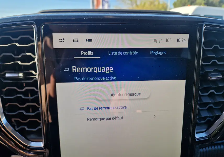 Écran central tactile du Ford Ranger Wildtrak 2026 affichant le menu remorquage, entouré de grilles d’aération noires.