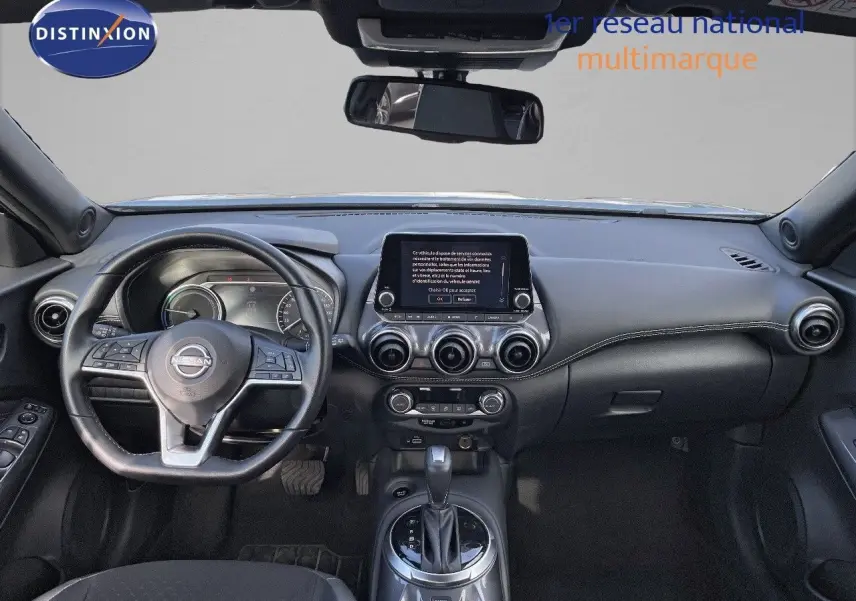 Intérieur noir du Nissan Juke 2024, vue frontale du tableau de bord avec écran tactile et volant multifonction.