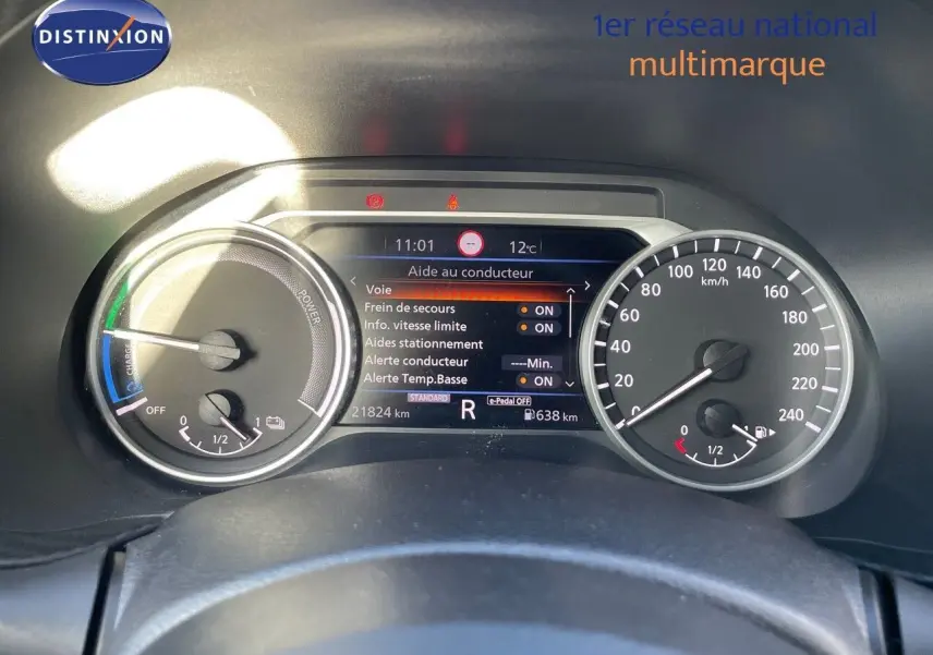 Tableau de bord du Nissan Juke 2024 noir métal, affichant l'aide au conducteur et compteurs numériques.