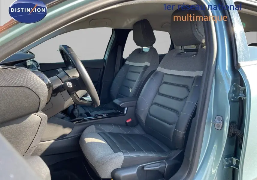 Vue intérieure côté gauche de la CITROEN C4 2021 bleu Iceland Metal avec sièges bi-matière cuir noir et tissu gris.