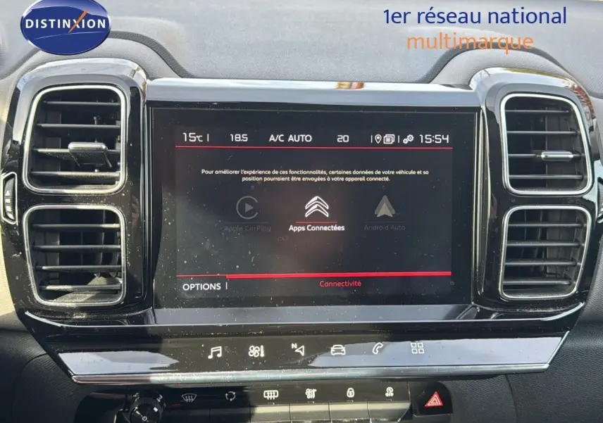 Écran tactile central du tableau de bord du Citroën C5 Aircross blanc nacré, avec commandes de climatisation visibles.