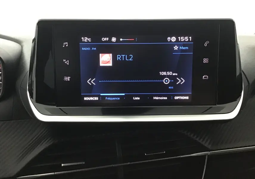 Écran tactile central du tableau de bord de la Peugeot 208 gris Artense, affichant la radio RTL2 à 106,5 MHz.