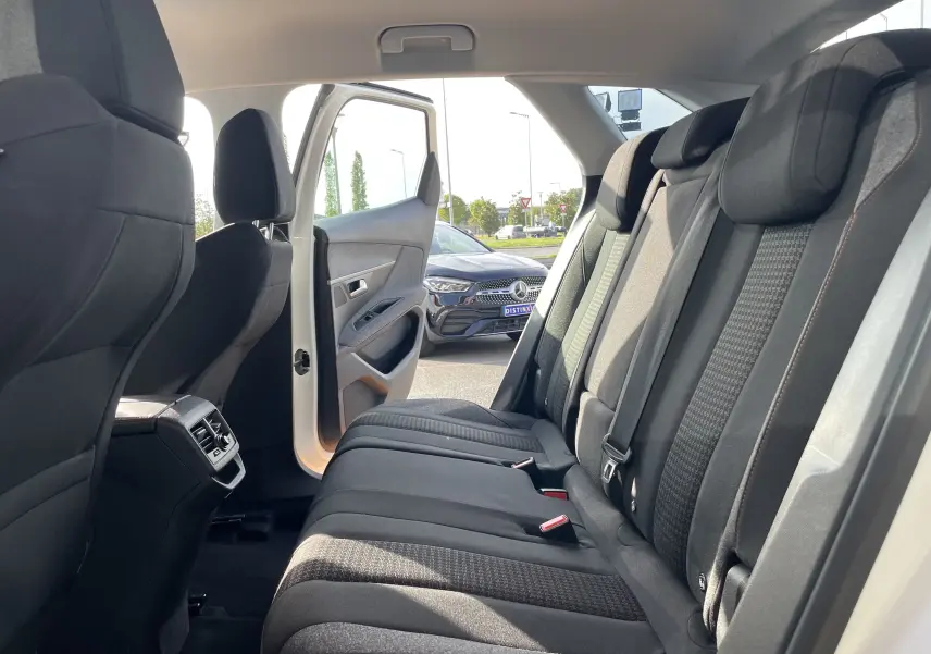 Vue intérieure arrière droite du Peugeot 3008 blanc 2018, montrant les sièges noirs et la portière ouverte.