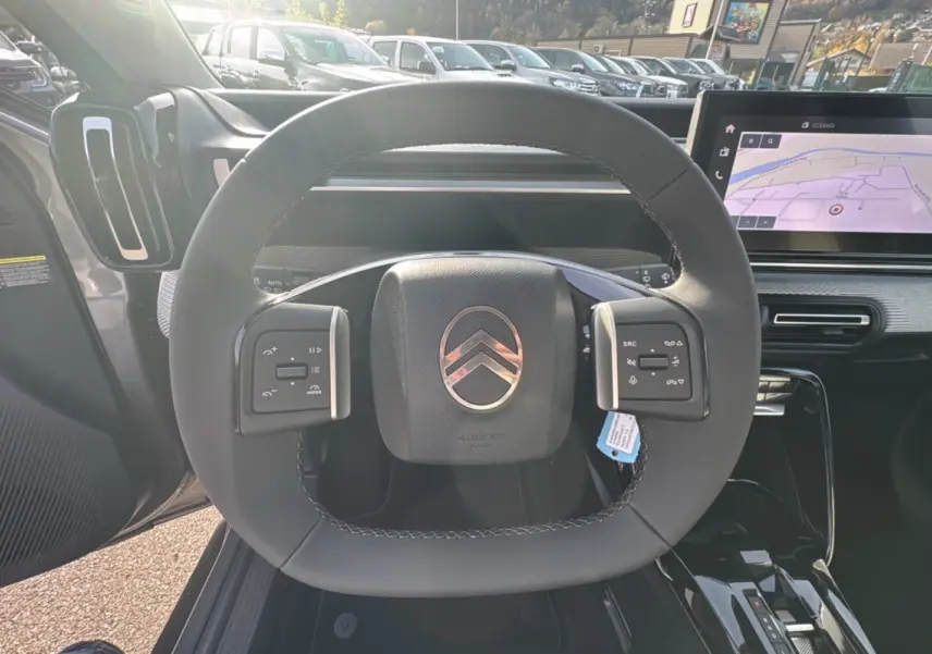 Volant cuir multifonctions de la Citroën C3 Aircross Hybrid 145, avec tableau de bord numérique et écran tactile GPS.
