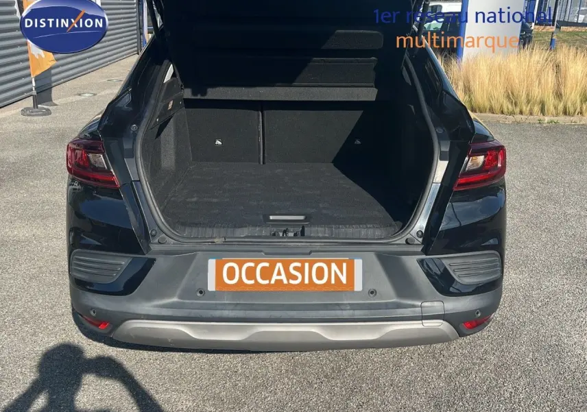 Coffre ouvert vu de l'arrière d'un Renault Arkana noir métal, montrant un espace de chargement spacieux et propre.