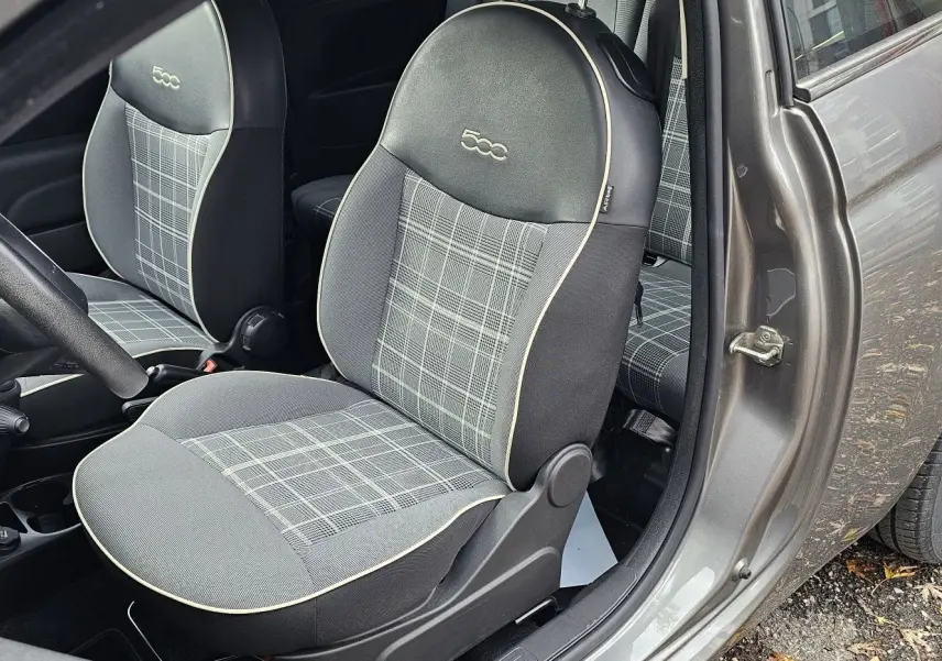 Profil droit d'une FIAT 500C grise électroclash avec toit rouge, sur fond neutre extérieur.