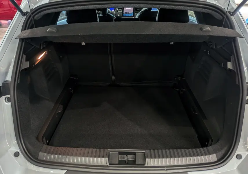 Coffre ouvert vu de l'arrière d'une Renault SYMBIOZ gris Rafale, montrant l'espace de chargement et la tablette cache-bagages.