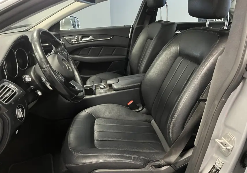 Intérieur noir cuir de la Mercedes Classe CLS 350 d 2015, vue côté conducteur avec volant multifonctions et console centrale.