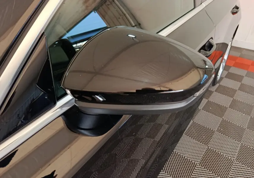 Rétroviseur droit noir brillant d’une Audi A3 35 TDI 150 S tronic Business Line, reflet de l’environnement intérieur.