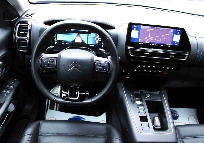 Intérieur du Citroën C5 Aircross hybride rechargeable, vue du poste de conduite avec écran tactile et volant multifonction.