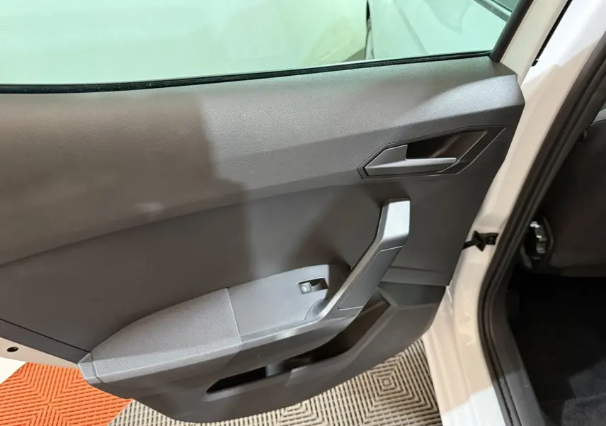 Vue intérieure sur la porte arrière droite blanche d'une SEAT IBIZA 1.0 TSI 110 FR avec garniture noire et poignée angulaire.