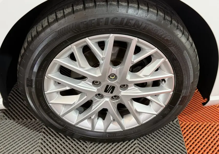 Gros plan sur la roue avant droite de la SEAT Ibiza blanche, mettant en valeur la jante alliage argentée au design moderne.