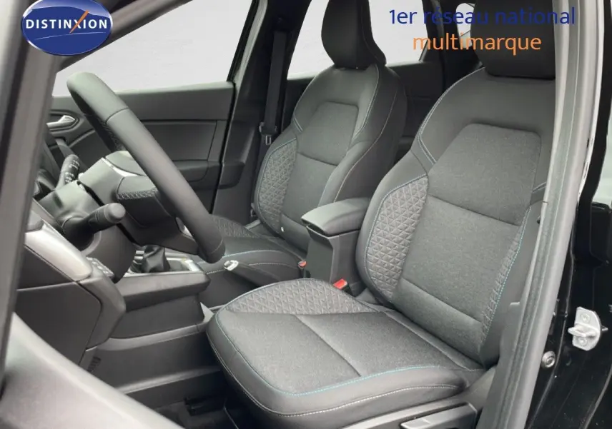 Vue intérieure côté gauche du Renault Captur 2025 noir étoile métal, mettant en valeur les sièges tissu gris avec surpiqûres bleues.