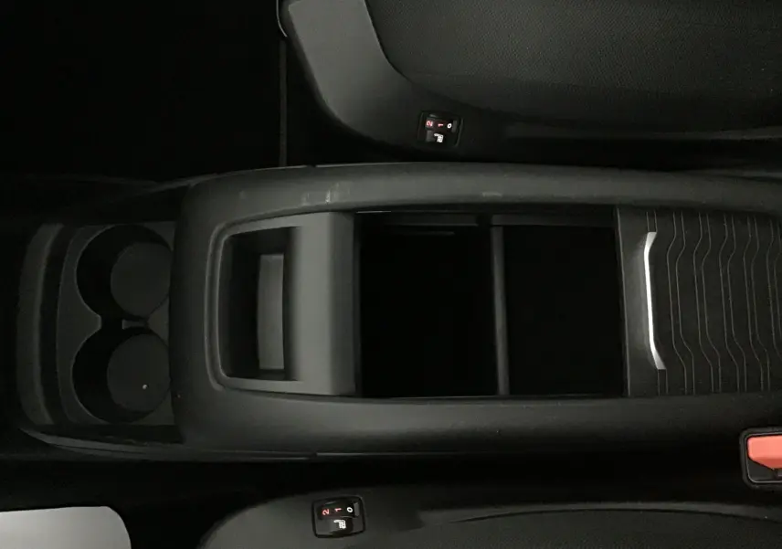 Vue plongeante sur la console centrale noire du Citroën Grand C4 Spacetourer gris, avec porte-gobelets et commandes sièges chauffants.