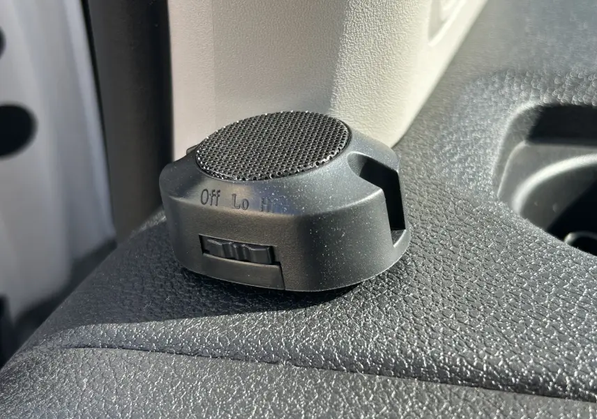 Gros plan sur un bouton de réglage noir avec molette sur tableau de bord texturé du Fiat Scudo Combi blanc électrique 2022.