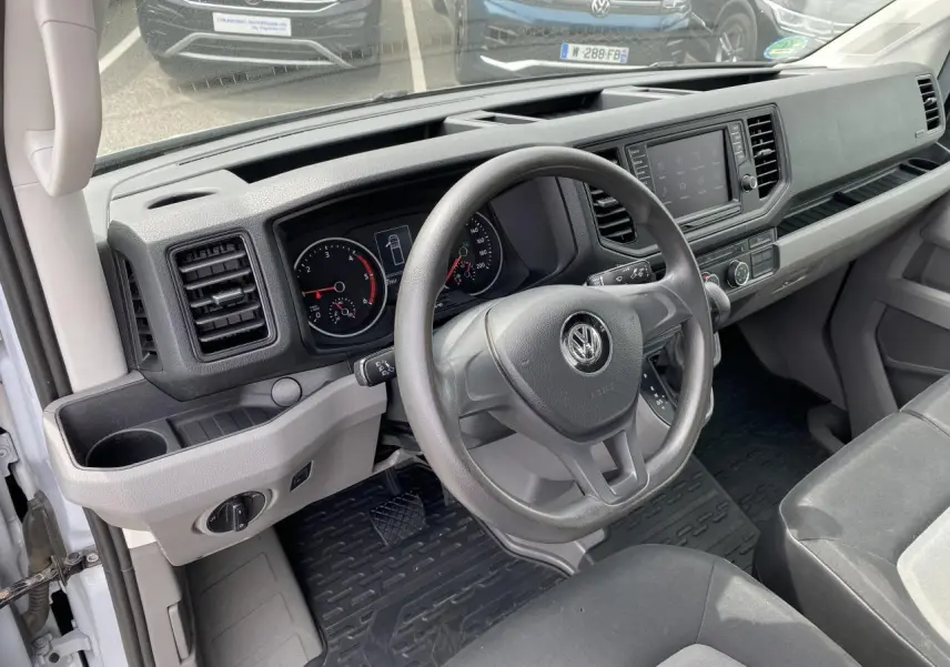 Intérieur du Volkswagen Crafter Business Line 2020, vue côté conducteur sur le tableau de bord et volant gris.