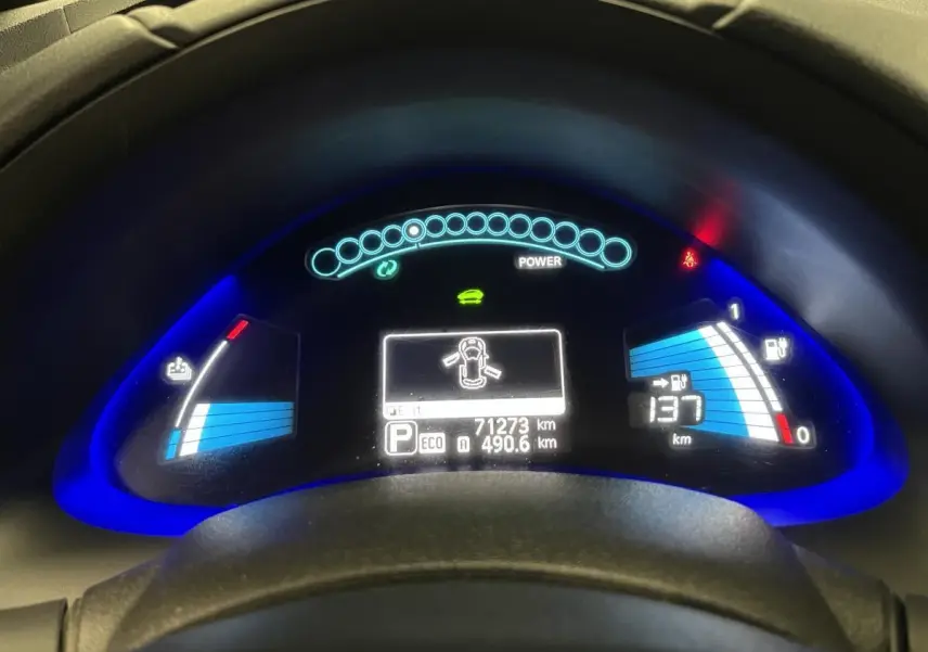 Tableau de bord éclairé de la Nissan Leaf 30 2017 rouge, affichant autonomie et indicateurs de charge électrique.