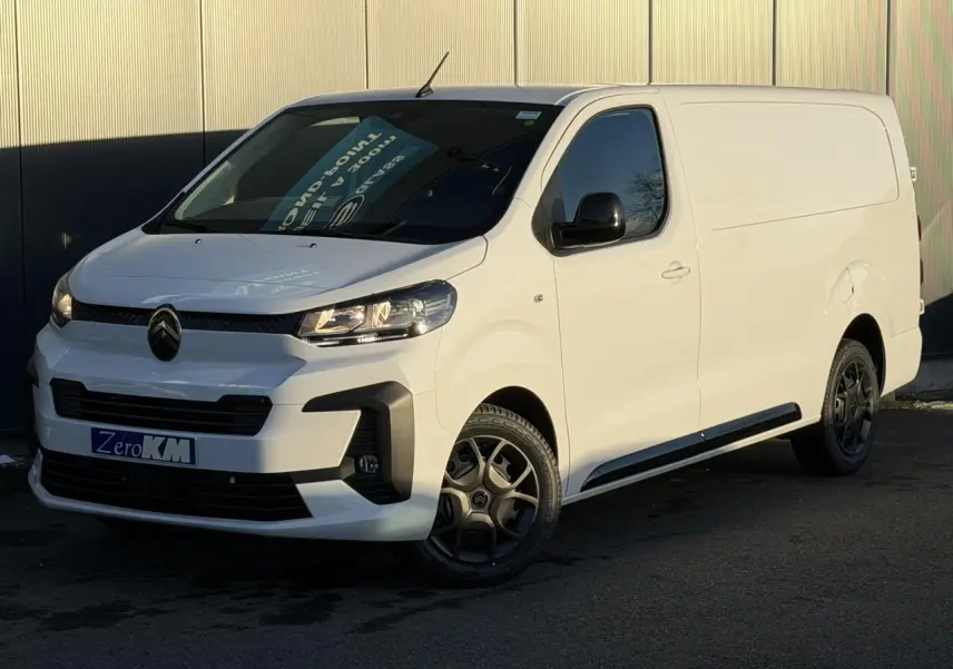 Vue 3/4 avant droit d'un utilitaire Citroën Jumpy XL blanc Icy avec coques de rétroviseurs noires et jantes foncées.