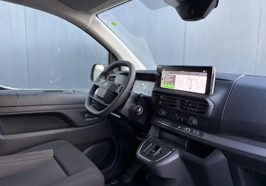 Vue intérieure côté conducteur du Citroën Jumpy XL gris Artense, avec tableau de bord moderne et écran GPS tactile.