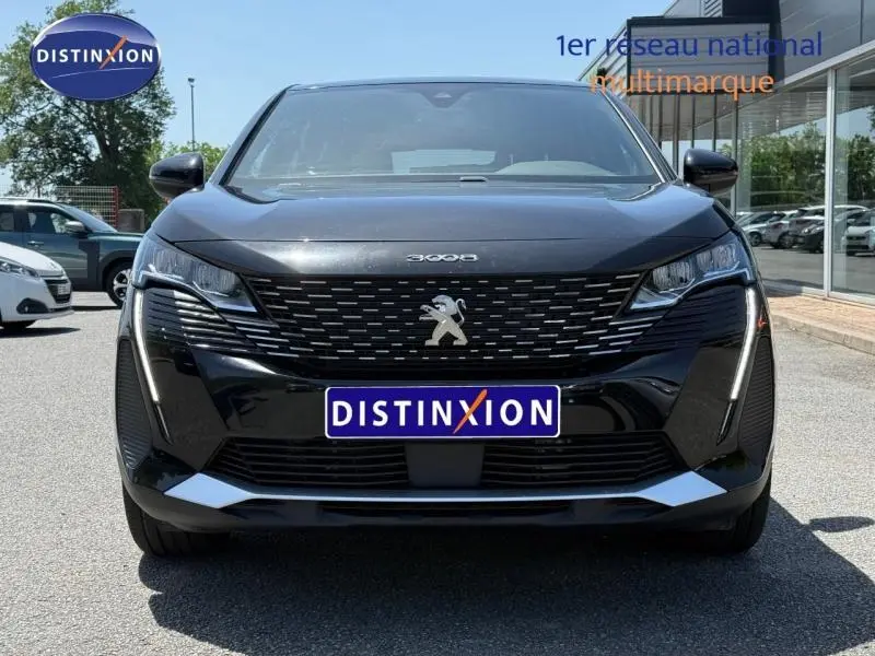 Vue frontale du Peugeot 3008 Hybride Rechargeable noir Perla Nera avec calandre distinctive et feux LED en griffes.