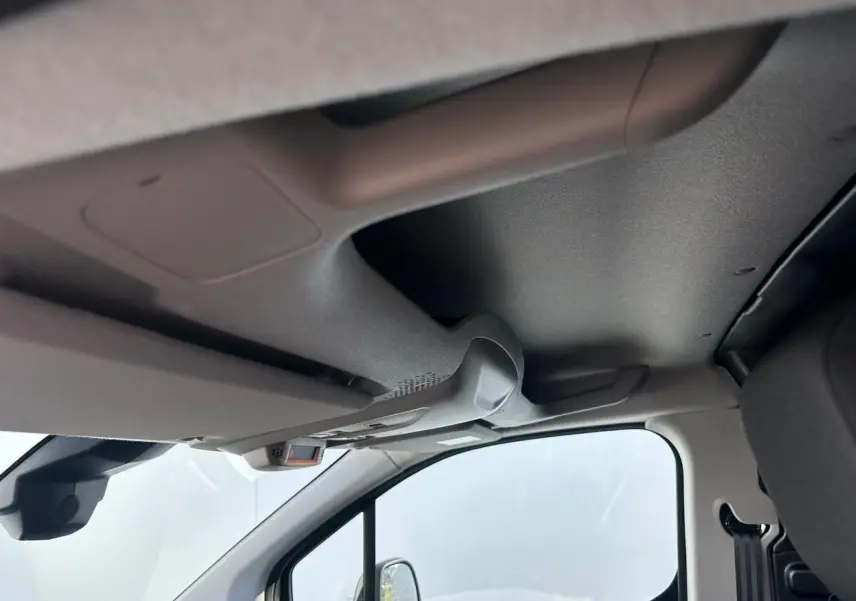 Vue intérieure côté conducteur du plafond et pare-soleil du Citroën Berlingo III blanc Icy, avec rétroviseur et partie de siège visible.