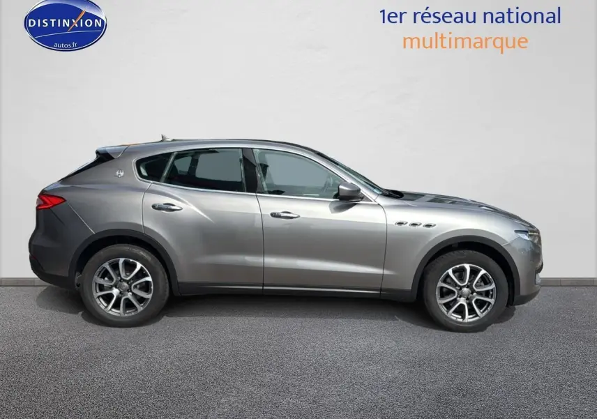 Profil côté gauche d'un Maserati Levante gris 2017 avec jantes alu et lignes élégantes sur fond neutre.