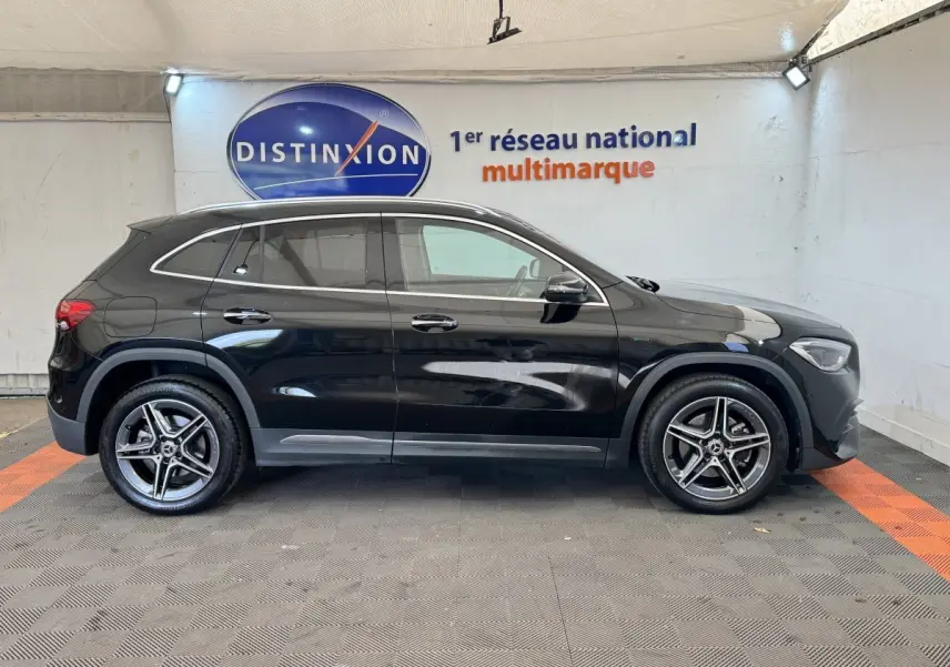 Vue de profil côté gauche d'un Mercedes GLA 250 e AMG Line noir avec jantes alliage et toit panoramique.