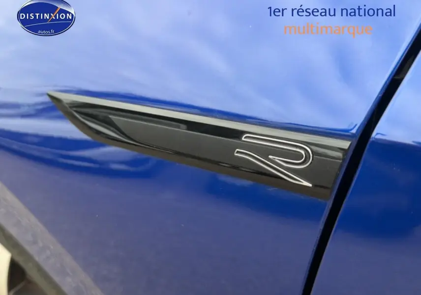Détail de l'emblème R noir sur la porte côté gauche d'une Volkswagen Golf bleue 2024.