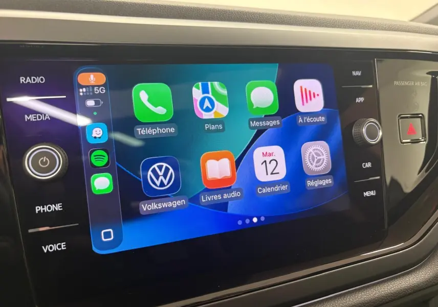 Écran tactile central du Volkswagen Taigo 2024 affichant l'interface Apple CarPlay avec plusieurs applications colorées.