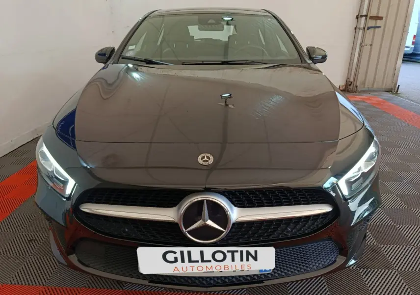 Vue avant d'une Mercedes Classe A 200 Business Line noire avec calandre chromée et phares LED allumés.