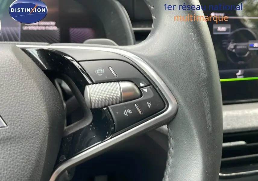 Gros plan sur les commandes au volant en cuir noir de la Skoda Scala 2025, version essence boîte auto.