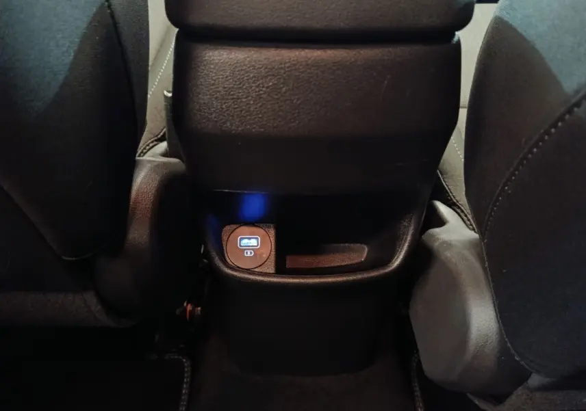 Vue rapprochée de la prise USB arrière entre les sièges avant du Hyundai Kona gris foncé 2023.