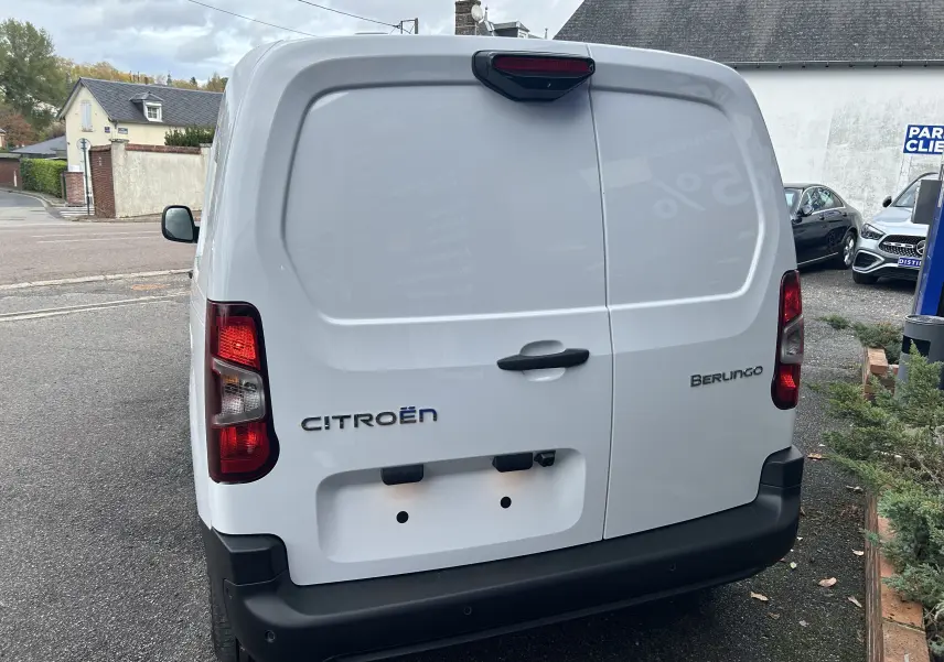 Vue arrière d'un Citroën Berlingo Fourgon blanc avec portes battantes et feux arrière rouges.