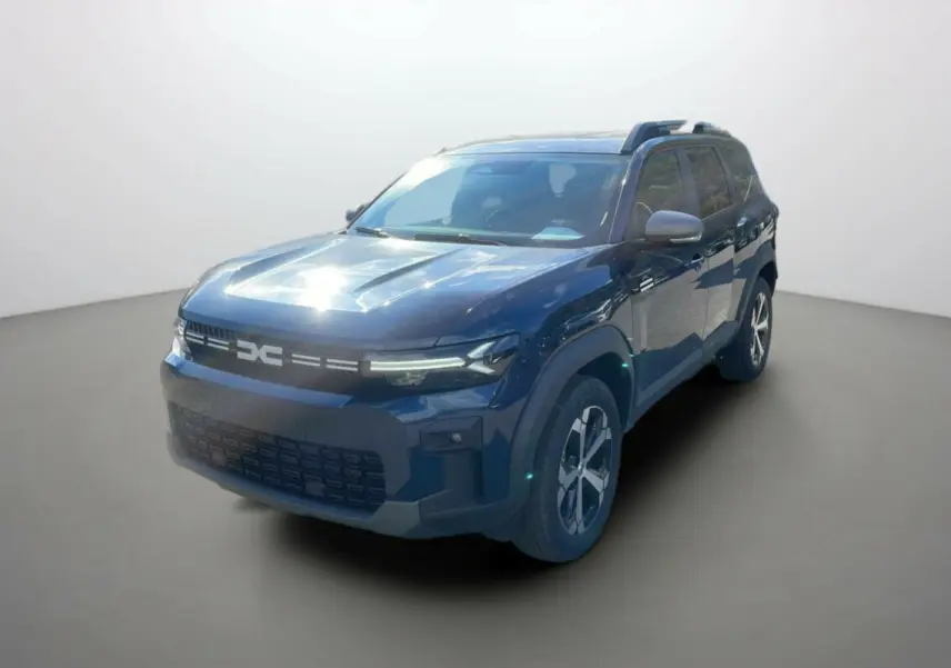 Dacia Bigster Hybrid 155 Journey City bleu indigo en 3/4 avant droit avec barres de toit et jantes alu.