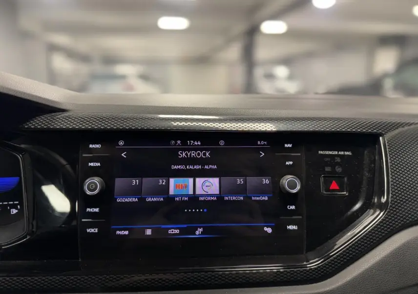 Écran tactile central 8 pouces du Volkswagen Taigo gris 2024, affichant la radio Skyrock dans l'habitacle.