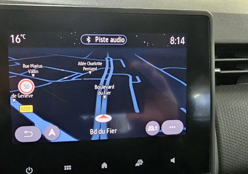 Écran tactile central du tableau de bord de la Renault Clio blanc glacier 2020 affichant la navigation GPS nocturne.