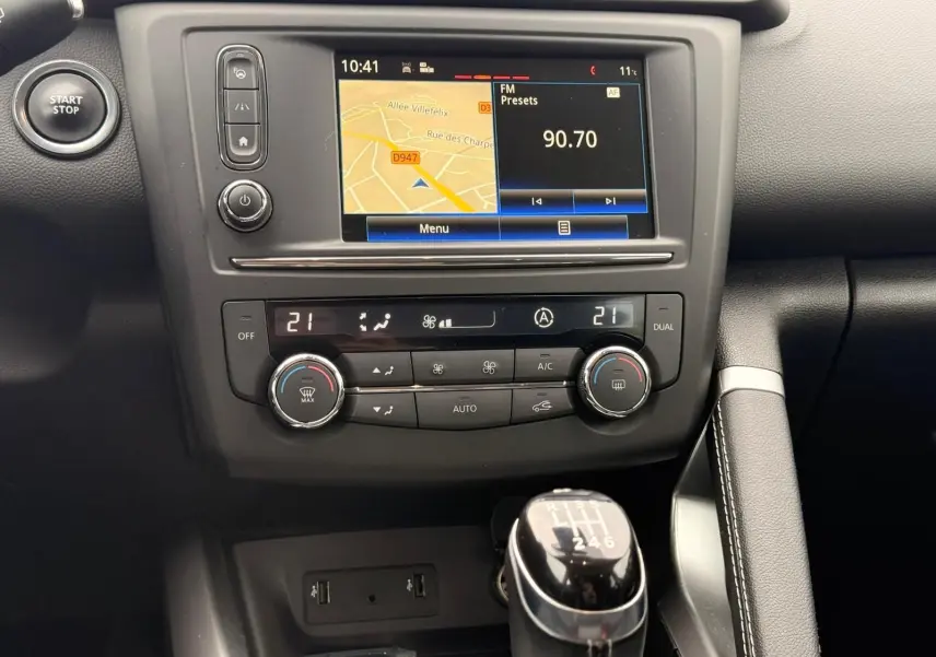 Vue rapprochée de la console centrale du Renault Kadjar 2016, avec écran tactile, climatisation et levier de vitesse manuel.