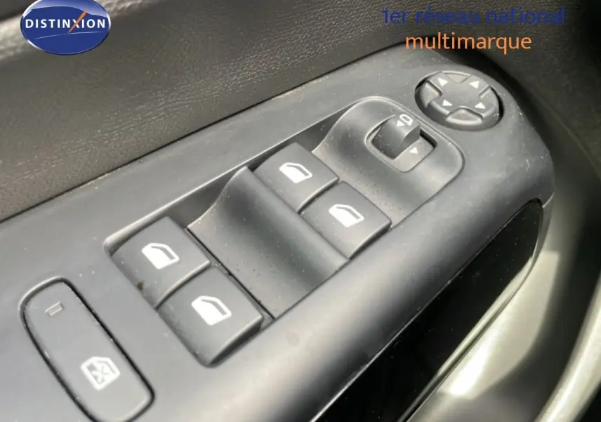 Gros plan sur les commandes des vitres électriques côté conducteur du Citroën C5 Aircross 2024 en intérieur noir.